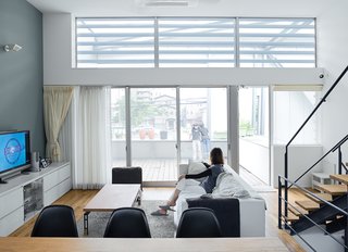 The family's hub is a high-ceilinged main room on the second level. It's open and casual and gets lovely morning light.