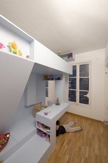 The beauty of the design is that there's no one way to use the space; the architects let the children determine how to use the different elements of the room. Though the desk is often used for tea parties and drawing, it can also become a handy hiding place from parents or a nosy toddler brother. "It's a house in the house," says Santiard. "What's better than hiding under a table to play?"