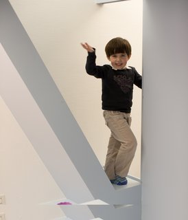 Eva clambers up and down steps from her bed to her brother Jean's sleeping area; hidden lighting makes it easy to find her way even at night. "She has a quiet pride in her world," says architect Antoine Santiard of Eva's new room.