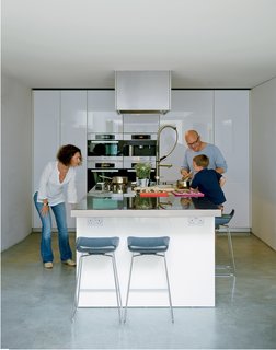 Composite Index - Photo 5 of 10 - Bruce and Kirsty loved the idea of a kitchen island rather than traditional work surfaces around the walls. Bruce fancies himself a chef and hates to have his back to everyone when he’s cooking. This island, from the Boffi LT line designed by Piero Lissoni, allows guests to gather around for impromptu sushi rolling or casual breakfasts.