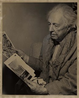 Here in this 1955 picture, Frank Lloyd Wright examines a photo of the Fontainebleau Hotel on Miami Beach.