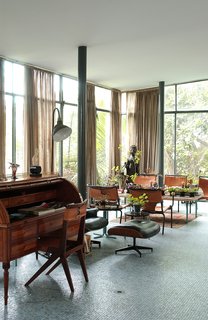 Lina Bo Bardi - Photo 8 of 14 - The living area of the Glass House held many of Bo Bardi’s furniture designs, including the desk chair and dining chairs. Both shared the similar elements of corsetlike back stitching, a motif still replicated today. Photo courtesy Espasso.