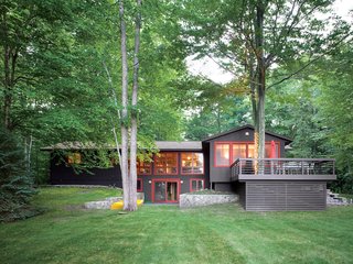 The rise of the front lawn and the height of the trees give the house a subtle presence amid magnificent surroundings.