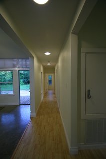 LA Tech-Habitat Home - Photo 12 of 17 - Inside the front door, a long hallway separates the public space, on the left, from the private space, which extends farther back on the right side of the home. Photo courtesy of Jared Boudreaux and Tim Hayes.