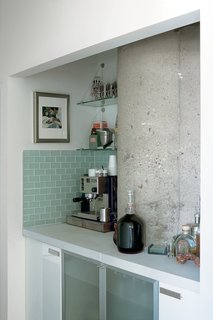 Arthur carved the Indiana limestone–clad bar out of an awkward space in the hallway.