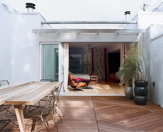 Project Runaway - Photo 13 of 14 - The bedroom flows into the new ipe deck, which houses a poplar table by Mike and Maaike and Drake chairs by One & Co, from Council Design.