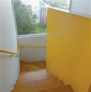 Bestor gave each area of the house its own color scheme. The bright yellow stairwell maintains a cheery mood throughout.