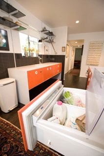 The designer eschewed expensive cabinetry in favor of powder-coated stainless steel, and found the Miele cooktop and oven at a floor sale. To keep things uncluttered, Popp installed a Sub-Zero under-counter refrigerator, a small Fisher & Paykel dishwasher and a simple Hansgrohe faucet, all found at a discount.