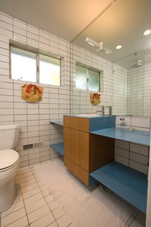 Popp created wood cabinetry surrounded by another powder-coated steel vanity "with a punch of blue" for the bathroom. In anticipation of the project, he took time to gather key elements, such as the bathroom’s Dornbracht faucet, at sale prices.
