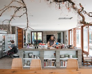 The cooking area features two islands—one more permanent than the other. A concrete island contains various appliances. With the extra surface area, there’s plenty of room to roll out dough and a wide berth for Ian’s power chair.