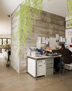 The open office space is partially secluded thanks to the hanging Algues by Ronan & Erwan Bouroullec for Vitra.