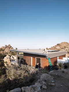 As a paean to the old steel-mining shacks that inspired the home, McAdam sprayed the the corrugated-steel exterior with apple cider vinegar to create a warm rust effect.
