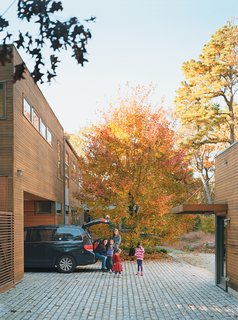 Kid Tested, Mothers Approved - Photo 7 of 8 - The house was deliberately sited to preserve the two-acre property’s existing trees, three of which can be seen protruding through the surface of a rear deck.
