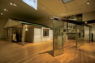 Inside, on the exhibition floor, museum-goers check out a Lustron Home.