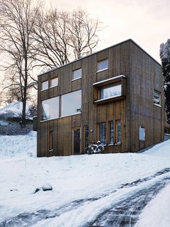 Knotty by Nature - Photo 2 of 25 - The facade is punctured by a variety of differently sized windows: Those flush to the wall indicate the house’s public rooms, while the those for the private spaces are set back.