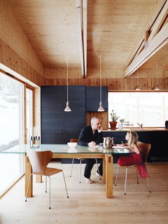 Knotty by Nature - Photo 6 of 25 - Bornstein and his daughter Velma sit at a table the architect designed himself; the dining chairs were designed by Arne Jacobsen for Fritz Hansen.