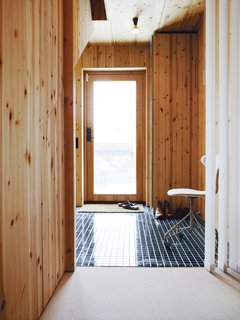 Knotty by Nature - Photo 5 of 25 - Though the house is a mostly wooden affair, a sense of transparency pervades, thanks to many windows and the glass front door.
