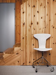 Knotty by Nature - Photo 8 of 25 - Competing grains of laminated pine panels enliven the stairs.