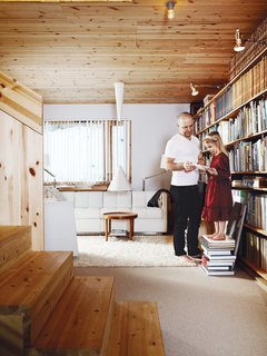 Knotty by Nature - Photo 9 of 25 - The first thing visitors see as they enter the house is Bornstein’s impressive collection of architecture and design books. The sofa and chair were designed by Bornstein for Swedese.