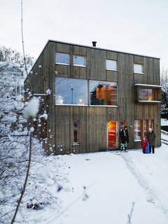 Knotty by Nature - Photo 23 of 25 - With the majority of the house's windows facing down the slope, not only does Bornstein maximize the views out, but he assured that his home would have loads of natural light pouring in, even if it only lasts for a few hours in winter.