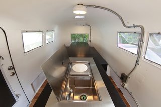 Hide and Sleep - Photo 2 of 10 - The steel lid opens up at one end of the island to reveal a sink and hot plate for cooking a meal. Photo by Sadamu Saito.