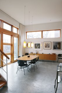 From Brown to Green - Photo 7 of 8 - The dining room has a mishmash of Eames chairs, found in various states and painted black.