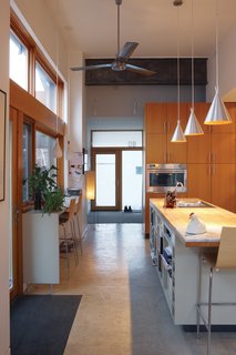 From Brown to Green - Photo 3 of 8 - The kitchen, which gets light from three sides, welcomes guests into the house.