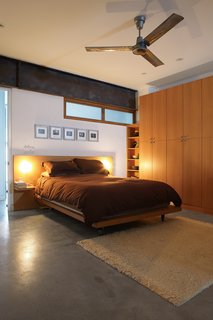 From Brown to Green - Photo 8 of 8 - Both the kitchen and the main bedroom blend polished concrete with white oak cabinets. Fleming spent almost six months building the house’s millwork, which lends the house a warm, bespoke quality.