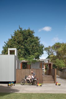In the suburb on the mountain’s lower slopes, Michael O’Sullivan and his sons Seamus and Finbar exchange motorcycle tips outside the compact, innovative home O’Sullivan designed.