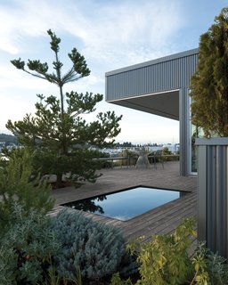 The reflecting pool is surrounded by foliage and breathtaking views of the bay.