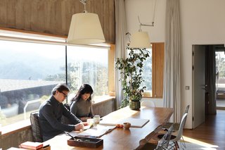 Light from windows on all four sides spills over the dining room’s custom-made teak table.