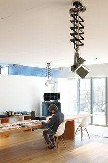 Light is a key element of the home’s design. Photography lights from a local manufacturer keep the basement studio bright.