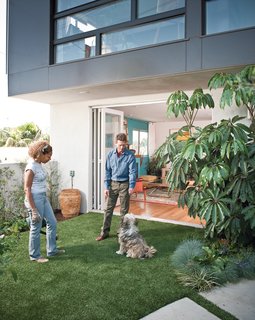 Lucky 7 - Photo 14 of 15 - They installed water-saving artificial grass on their patio for pup Moxy to enjoy.