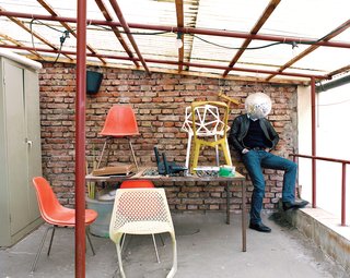 Industrial Designer Focus: Konstantin Grcic - Photo 3 of 26 - The "terrace", in his unassuming former factory space not far from the main train station in Munich, is a place where he and his cohorts can step outside for a breath of fresh air. A handful of classics as well as his own chairs—–like the Myto (foreground) and the Chair One (on the table at right)—–upstage the suddenly bashful designer.