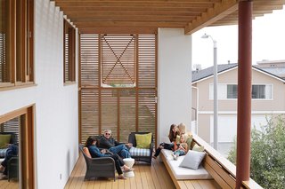 Coast Docs - Photo 5 of 13 - Cedar louvers increase privacy and shade on the second-floor deck, where Carole and Duane relax with granddaughters Natalie and Allison and their friend Katherine.