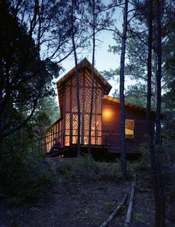 "I wanted more of a skeletal look for this house, and less of a chunky, log-cabin look," says Panton, who added stark steel bracing across the entire length of the porch’s roof structure.