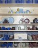 A tableau of tableware at the Ferry Building location shows the range of glaze options and styles of stoneware available. This year’s summer collection is featured on the top shelf, above platters, mugs, bowls, and a small teapot from the traditional Coupe line on the second shelf from the top. Dessert bowls, salt and pepper shakers, pitchers, pasta bowls and more round out the display. Photo of Factory Direct modern home
