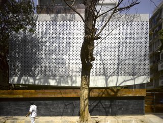 Working within the restraints of the sometimes-severe Mumbai weather and around the city's great architectural varieties, not to mention the existing coconut palms and banyan trees, architectural firm Khanna Schultz constructed a 27,000-square-foot-plus, seven-unit modern apartment building with a striking open-air base. At front is the street-side boundary wall made up of a stone base and a planter on top, which is meant to fill in with foliage over time. The curved base of the building is cantilevered about 10 feet. "This has to do with zoning and fire codes," notes Schultz. "But since you don't see the columns, it seems like the whole building is floating."