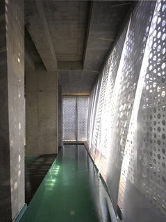 The pull-down scrims over the lap pool move with the breeze within the public space.