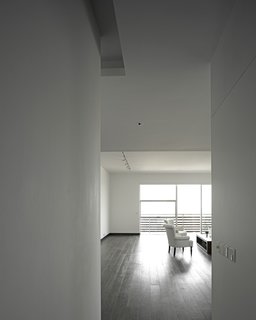 The owner's apartment, which incorporates a double-height space in some areas, has teak floors, whereas the other units have more industrial concrete floors.