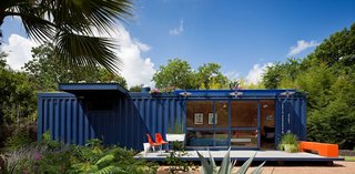 While shopping for containers, Hill was instantly drawn to this one’s existing blue color and chose to buy it and leave it as is. Poteet added floor-to-ceiling sliding doors to allow light in, as well as a cantilevered overhang to shade a window on the left side, which houses a small garden storage area.