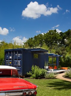 Hill’s 1962 Mercury Monterey complements the blue of the container, whose original opening was retained on one end as the entrance to the garden storage shed.