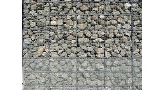 The Stealth Winery - Photo 2 of 9 - The exterior walls of the structure are industrial wire cages filled with locally sourced basalt.