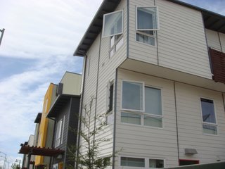 Budget materials, like the Hardie Board siding seen here, helped keep construction costs down and adds visual interest to the exteriors of the townhouses.