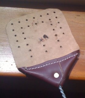 Here's a photo I nabbed from Farm Natters that shows some fly remains stuck to the back of the swatter. Better to get at those beasties with the front side, it seems.