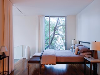 A pair of mid-century Martz lamps flank the Parsons bed from Room & Board in the master bedroom.