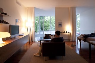 By dint of the double-height ceiling in the dining area, the master bedroom has a nice view out to the courtyard. Though a mere pull of a pair of curtains is all that's needed to block out the light.