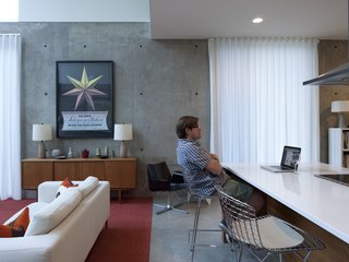 Scott Winter determines precisely what his laptop is telling him at the kitchen bar. The poster on the wall behind him celebrates the Schubert opera Snow White.