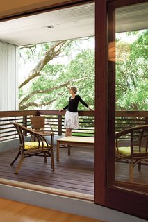 Susan enjoys the protected terrace just outside the glass doors.