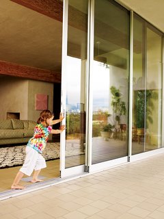 How a Bungalow Went from Bland to Brilliant - Photo 5 of 9 - Drama comes from a 14-foot-tall and 26-foot-long glass wall that opens up the entire living room to the elements.